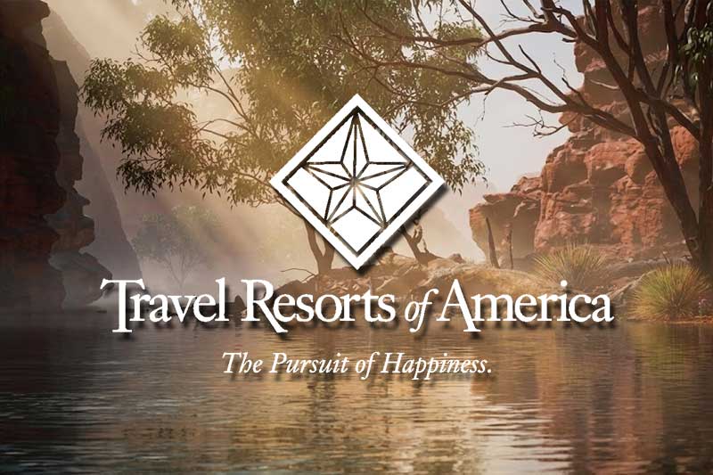 Travel Resorts of America Campground Membership Resales A luxury fifth-wheel RV trailer neatly parked on a spacious campsite at a Travel Resorts of America private campground resort surrounded by mature woods.